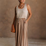 Full body front view of female model wearing the Bristol Mocha & Tan Maxi Dress that has a tan knit upper with thick straps, a mocha maxi skirt, and a drawstring waist. 