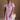 Upper body front view of female model wearing the Cameron Pink & White Striped Dress that has pink and white vertical striped fabric, short puff sleeves, a tiered skirt, and button up front.