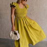 Full body front view of female model wearing the Kristina Chartreuse Smocked Sleeveless Midi Dress that has chartreuse fabric with a smocked upper, ruffle straps, and a midi length hem.
