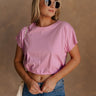 Upper body front view of female model wearing the Belle Pink Short Sleeve Crop Top that has pink fabric, short sleeves, a round neck, and a cropped waist. Worn with jeans.