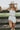 Front view of female model wearing the Saylor White Denim Strapless Romper which features Off White Denim Fabric, Light Brown Stitch Details, Two Front Pockets, Two Back Pockets, Belt Loops, Back Zipper and Strapless