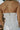 Back view of female model wearing the Saylor White Denim Strapless Romper which features Off White Denim Fabric, Light Brown Stitch Details, Two Front Pockets, Two Back Pockets, Belt Loops, Back Zipper and Strapless