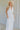 Front view of female model wearing the Alayna White Linen Sleeveless Maxi Dress which features White Linen Fabric, Fray Hem Details, Quarter Button-Up, Collared Neckline and Sleeveless