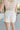Back view of female model wearing the Ivy White Drawstring Tie Shorts which features White Lightweight Fabric, Pockets On Each Side, Elastic Waistband and Drawstring Tie