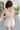 Back view of female model wearing the Ivy White Drawstring Tie Shorts which features White Lightweight Fabric, Pockets On Each Side, Elastic Waistband and Drawstring Tie