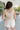 Back view of female model wearing the Ivy White Drawstring Tie Shorts which features White Lightweight Fabric, Pockets On Each Side, Elastic Waistband and Drawstring Tie