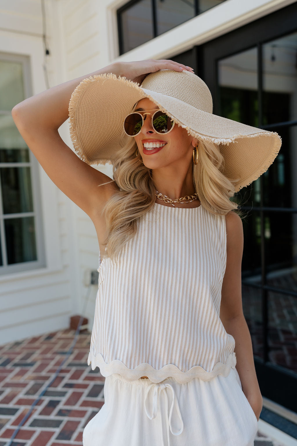 Front view of female model wearing the Lydia Tan & Cream Stripe Scallop Hem Tank which features Khaki and White Stripe Pattern, Scalloped Hem Detail, White Lining, Round Neckline, Sleeveless and Back Zipper Closure