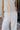 Close up view of female model wearing the Alice Off White Wide Leg Drawstring Pants which features Off White Lightweight Linen Fabric, Off White Lining, Wide Pant Legs, Side Pockets and Elastic Waistband with Drawstring Tie