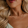 A model is shown in a close-up. She is wearing the Magdelene Necklace in Crystal.