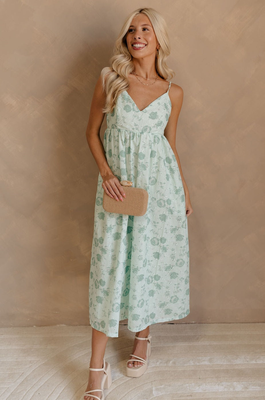 Full body view of female model wearing the Kira Mint Green Floral Midi Dress which features Mint green fabric, Green floral print, Floral eyelet embroidery, V-neckline, Adjustable straps and Green lining