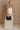 Full body view of female model wearing the Ellie White & Oatmeal Strapless Maxi Dress which features White Ribbed Upper, Oatmeal Linen Fabric, Maxi Length, Back Slit Detail and Strapless