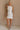 Full body view of female model wearing the Isla White Silver Ruched Halter Neckline Mini Dress which features White Silver Fabric, White Lining, Ruched Details, Overlap Hem, Halter Neckline and Monochrome Back Zipper with Hook Closure