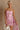 Front view of female model wearing the Willow Pink Floral Ruched Mini Dress which features Pink, Light Pink and Green Sheer Fabric, Rose Pattern Detail, Ruched Details, Mini Length, Pink Lining, Drape Detail, Strapless and Monochrome Back Zipper with Hook Closure