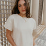 Front view of female model wearing the Willow Cream Woven Short Sleeve Top which features Cream and White Woven Design, Thick Hem, Round Neckline and Short Sleeves