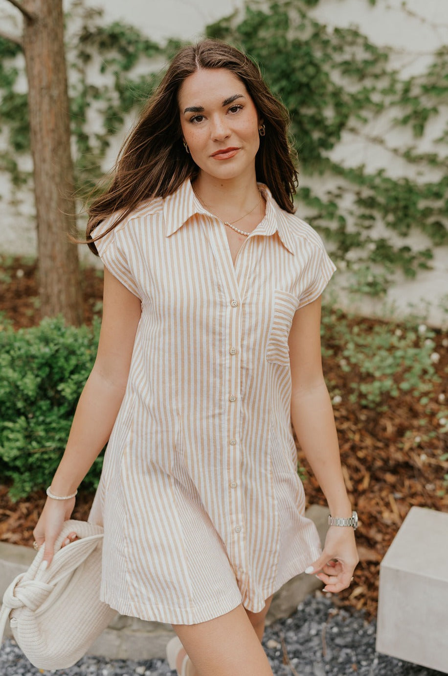 Front view of female model wearing the Naomi Yellow & Cream Stripe Button-Up Dress which features Yellow and White Stripe Cotton Fabric, Pockets on each side, Flare Skirt, Light Wooden Front Button-Up, Collared Neckline, Short Sleeves and Left Front Chest Pocket