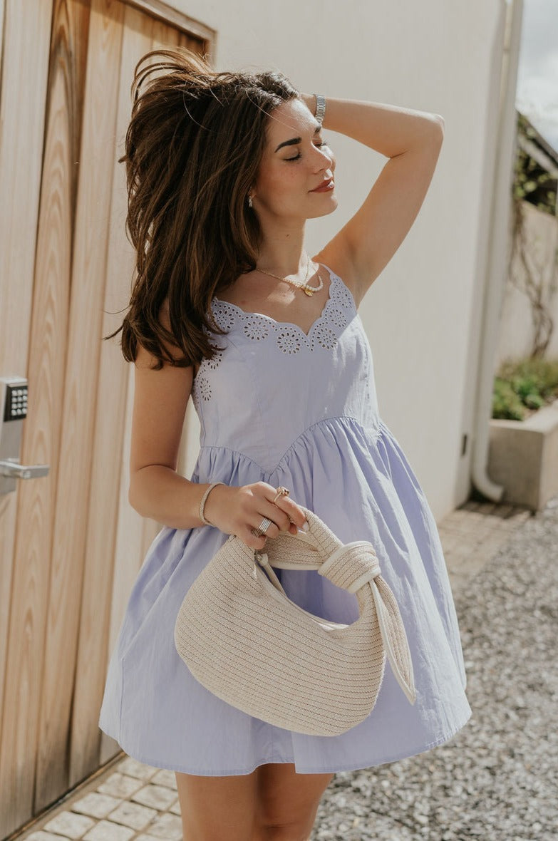 Front view of female model wearing the Lucia Lavender Eyelet Sleeveless Mini Dress which features Lavender Lightweight Fabric, Lavender Lining, Mini Length, Eyelet Pattern, Scalloped Upper Hem and Adjustable Straps
