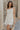 Front view of female model wearing the Blakely Ecru Crochet Babydoll Mini Dress which features Ecru Lightweight Fabric, Ecru Crochet Knit Upper, Ecru Lining, Mini Length, Tie Straps and Scoop Neckline