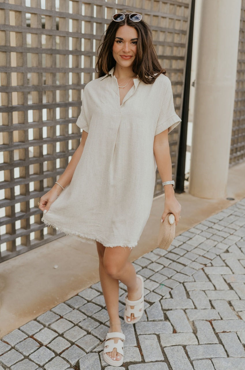 Full body view of female model wearing the Juliette Linen Fray Mini Dress which features Linen Lightweight Fabric, Fray Hem Details, V-Neckline with a Collar and Folded Short Sleeves