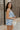 Side view of female model wearing the Lainey Blue & White Cropped Tank which features Blue and White Lightweight Fabric, White Lining, Monochrome side zipper with hook closure, Square Neckline and Thick Straps