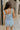 Back view of female model wearing the Lainey Blue & White Cropped Tank which features Blue and White Lightweight Fabric, White Lining, Monochrome side zipper with hook closure, Square Neckline and Thick Straps