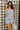 Front view of female model wearing the Lainey Blue & White Cropped Tank which features Blue and White Lightweight Fabric, White Lining, Monochrome side zipper with hook closure, Square Neckline and Thick Straps