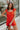 Front view of female model wearing the Rosalie Red Sleeveless Romper which features Tomato Red Lightweight Fabric, Ruffle Hem, Elastic Waistband, Square Neckline and Thick Straps with Tie Details