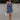 Full body view of female model wearing the Lena Navy & White Polka Dot Strapless Mini Dress which features Navy and Cream Polka Dot Design, Ruffle Hem Skirt, Upper Ruffle Detail and Strapless