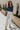 Full body view of female model wearing the Chloe Medium Denim Fray Sleeveless Top which features Medium Denim Blue Fabric, Fray Hem, Upper Ruched Details, V-Neckline and Sleeveless