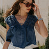 Front view of female model wearing the Chloe Medium Denim Fray Sleeveless Top which features Medium Denim Blue Fabric, Fray Hem, Upper Ruched Details, V-Neckline and Sleeveless