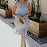 Full body view of female model wearing the Laurel Light Blue Slit Midi Dress which features  Light Blue Lightweight Fabric, Ruffle Hem, Light Blue Lining, Midi Length, Textured Details, Square Neckline and Tie Straps