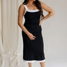 Full body view of female model wearing the Marissa Black & White Trim Midi Dress which features Black Lightweight Fabric, Midi Length, Black Lining, White Trim Details, Back Slit , Square Necklineand Side Monochrome Zipper with Hook Closure