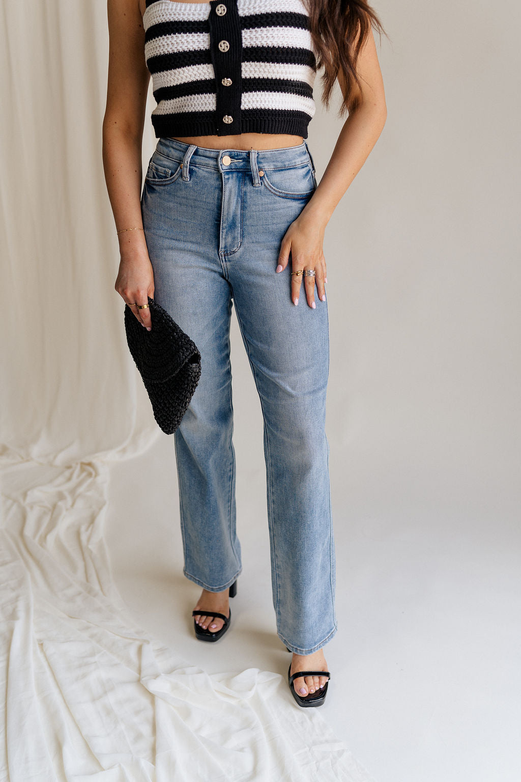 Front view of female model wearing the Eliana Medium Wash Straight Leg Jeans which features Medium Wash Denim Fabric, Straight Leg, High Waist, Two Front Pockets, Two Back Pockets, Front Zipper with Button Closure and Belt Loops
