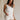 Front view of female model wearing the Monroe Off White Satin Tank Top that has off white satin fabric and a v-neckline.