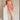 Full body front view of female model wearing the Reyna Peach Ruffle Strapless Midi Dress, that has peach fabric, a strapless neck, a ruffle detail, and midi length hem.