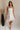 full body view of female model wearing the Lucia White Eyelet Strapless Mini Dress which features White Eyelet Pattern, White Lining, Mini Length, Flare Hem Skirt and Strapless