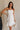 Front view of female model wearing the Lucia White Eyelet Strapless Mini Dress which features White Eyelet Pattern, White Lining, Mini Length, Flare Hem Skirt and Strapless