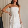 Front view of female model wearing the Lucia White Eyelet Strapless Mini Dress which features White Eyelet Pattern, White Lining, Mini Length, Flare Hem Skirt and Strapless