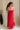 Full body back view of female model wearing the Sarah Red Ruffle Hem Midi Dress which features Red Lightweight Fabric, Flare Hem Skirt, Midi Length, Red Lining, Ruched Upper, Strapless and Smocked Back