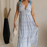 Full body view of female model wearing the Palmer Ivory & Blue Floral Tie Straps Midi Dress which features Light Blue and White Floral Print, Plisse Textured Fabric, White Lining, Tiered Body, Midi Length, Plunge Neckline and Blue Tie Straps