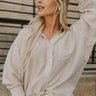 Close up front view of a female wearing the Madison button up stripe blouse.  It is front tucked featured with white denim shorts.