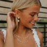 Side view of a model earing the Odessa Pearl Earrings.