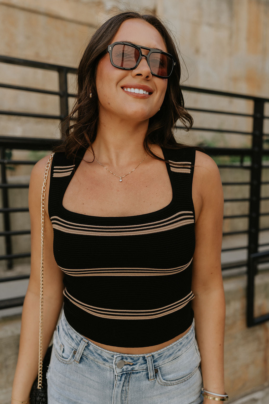 Close up view of female model wearing the Shayna Stripe Square Neckline Tank which features Ribbed Fabric, Stripe Pattern, Square Neckline and Sleeveless. the tank is available in black and white