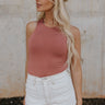 Front view of female model wearing the Maria Dusty Mauve Sleeveless Bodysuit which features Dusty Mauve Lightweight Fabric, Round Neckline, Sleeveless and Thong Bottom with Button Snap Closure