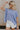 Front view of female model wearing the Nova Thread Short Sleeve Top which features Cotton Fabric, Curved Hem Details, Round Neckline and Shorts Sleeves. the top is available in blue and white