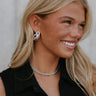 Side view of a model wearing the Drew Chain Earrings in silver