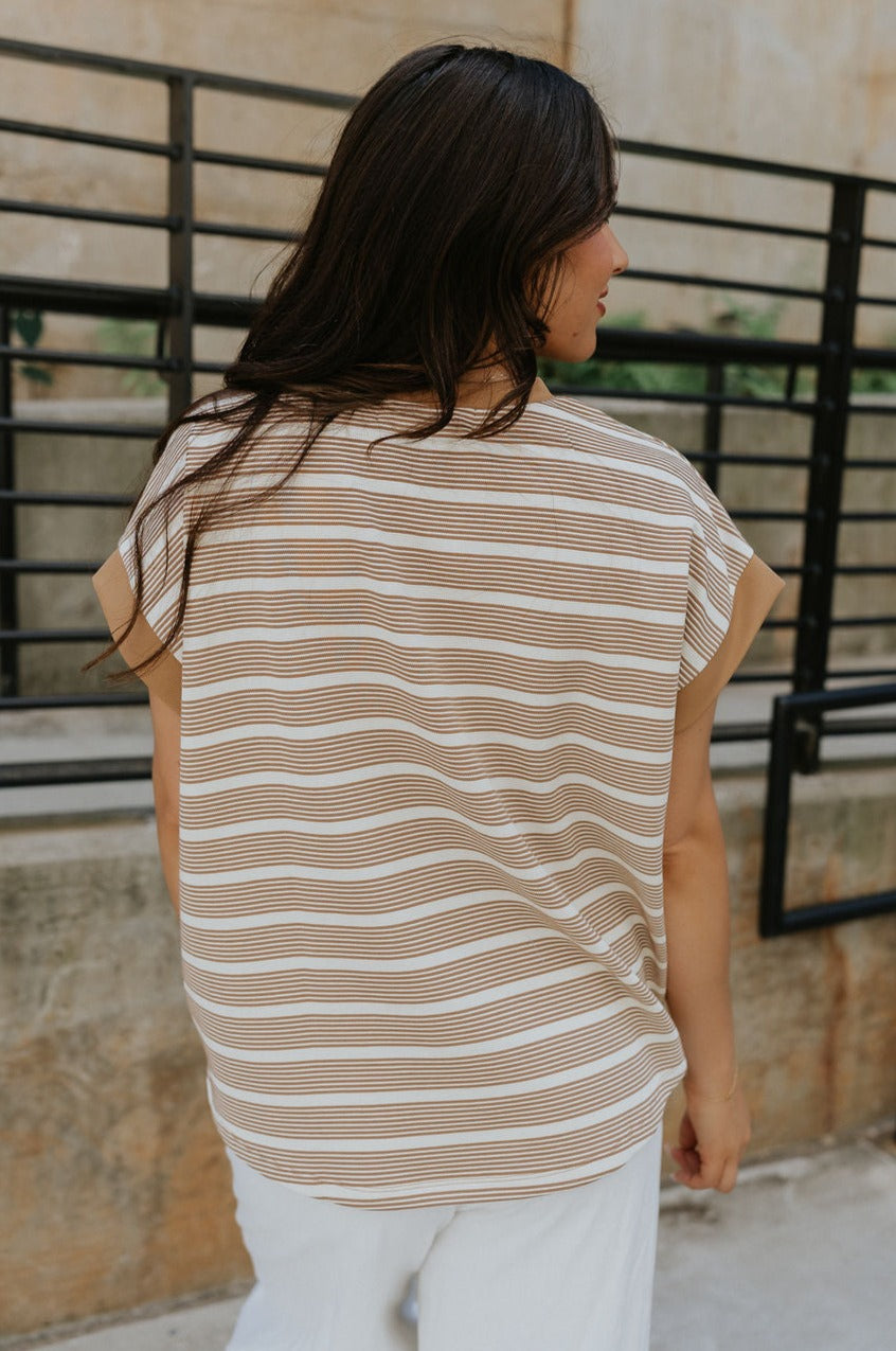 Back view of female model wearing the Celeste Taupe & White Stripe Short Sleeve Top which features Taupe and Cream Lightweight Fabric, Thin Stripe Pattern, Round Neckline and Short Sleeves