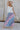 Full body view of female model wearing the Lily Aqua & Pink Multi Pleated Maxi Skirt which features Blue, Pink, Red, Purple and Aqua Floral Print, Satin Pleated Fabric, Maxi Length, Light Blue Lining and Side Zipper with Hook Closure