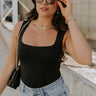 Front view of female model wearing the Andrea Black Square Neckline Sleeveless Bodysuit which features Black Lightweight Fabric, Square Neckline, Sleeveless and Thong Bottom with Button Snap Closure