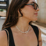 The model is shown from the side. She is wearing the Jessica Knot necklace. 