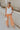 Full body view of female model wearing the Kennedy Apricot Orange Wide Leg Pants which features Orange Denim Stretch Fabric, Cropped Wide Pant Leg, Front Zipper with Button Closure, Belt Loops, Two Front Pockets andTwo Back Pockets